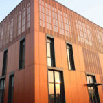 Itaca wooden cladding with copper finish on the exterior which transforms into jali on the terrace levels