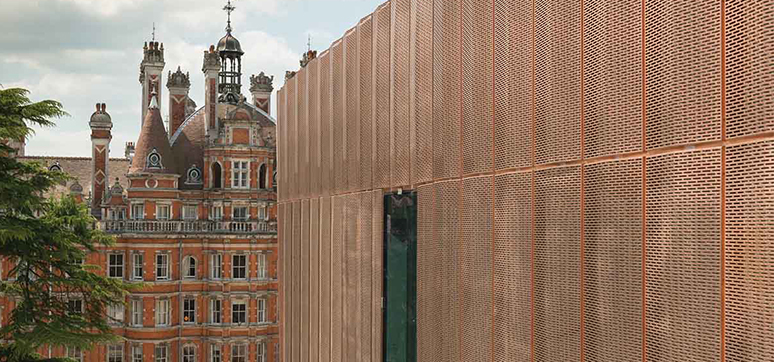 Tiled Perforated copper panels used for light to enter the interiors (Royal Holloway, University of London - Copper Recess Fixed Cassettes on BENCHMARK Karrier system during installation)