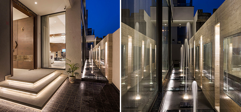 The entrance of the house, and the appealing water fountain, which connects the service staircase, acts as a sustainable element paving way for passive cooling