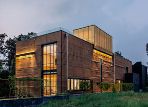 Timber panels and glass meet in the façade & cladding design 