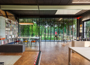 Architecture Discipline’s glazed studio walls, looking out onto a verdant landscape