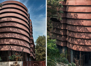 A metal shell has been enveloped around the structure to protect the interiors from the hostile and acrid environment. The curved form is reflected on the exterior façade and helps draw the eye towards it
