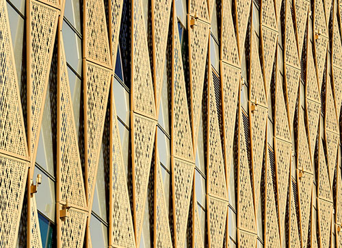 The geometry of the wood shading fins covers multiple building façades.