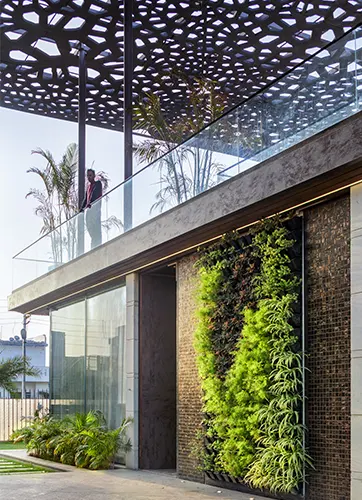The vertical greens and a shaded double height pergola on top