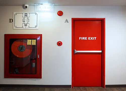Staircase fire exit door - Showing fire exit plan, fire exit door with panic handle, Fire Alarm to direct and escape person trapped inside and fire extinguisher and water extinguisher to slow down the active fire