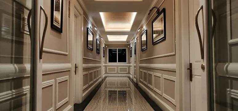 A project by Rahul Mehta Architects - corriddor with classic handles and panelled doors