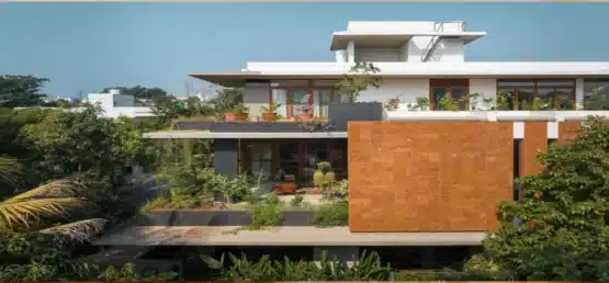Facade showing laterite stone cladding & wooden doors & windows