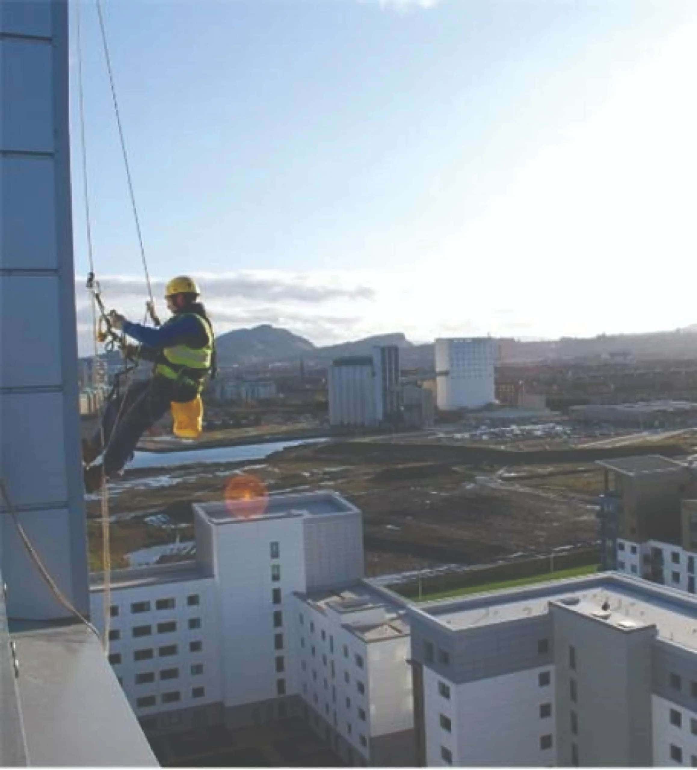 Image Credit – SG Access - A rope access technician at work on a curtain wall