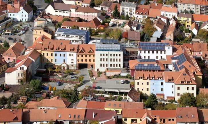 A deterrent example of photovoltaics use (high remote visibility in a very sensitive context), roof-mounted PV installations on a residential block in the urban conservation area of Mikulov, Czech Republic (Image Credit – Glass On Web. Com)