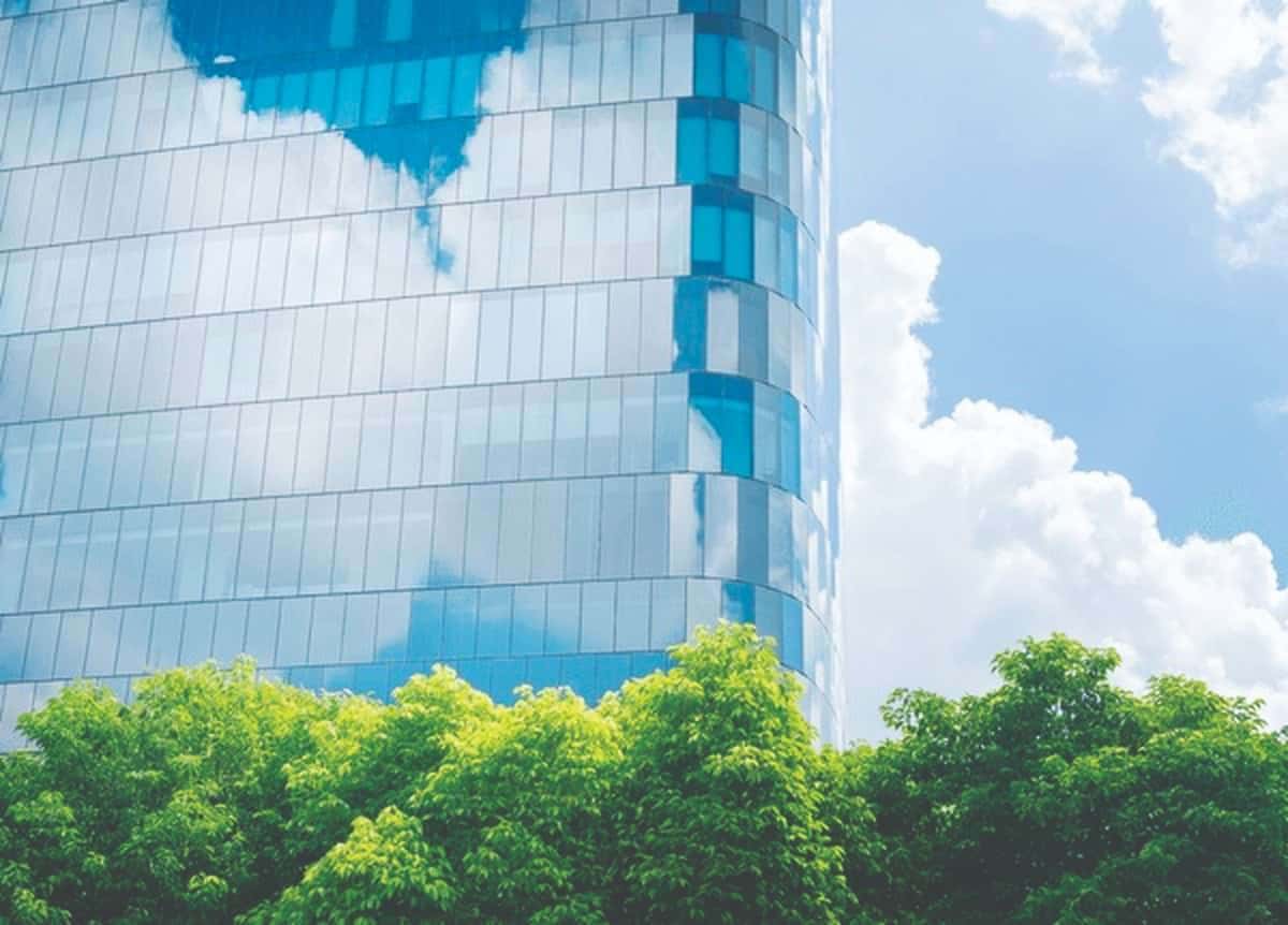 Electrochromic and thermochromic glass adjust transparency based on environmental conditions, reducing glare and cooling loads