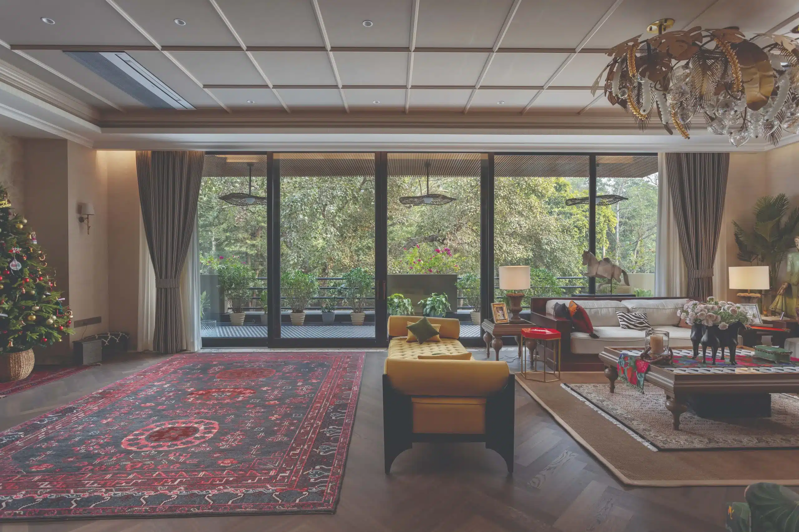 Large windows blur the boundary between inside and out, filling the living spaces with soft, natural light that amplifies the serene ambience