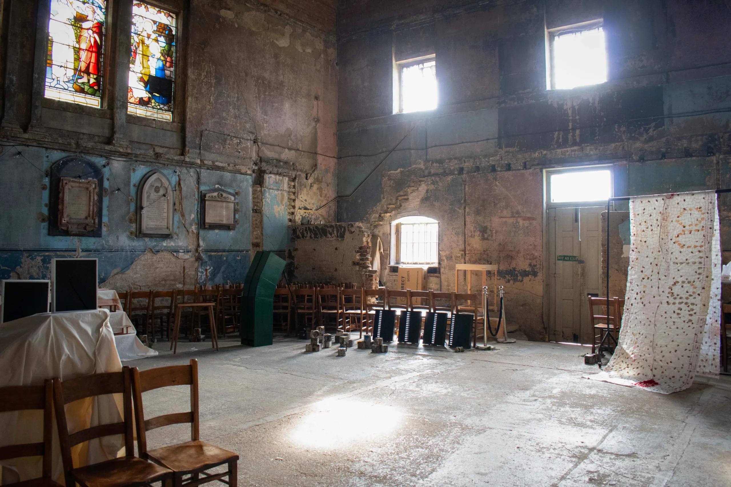 Larger openings let in direct sunlight, grazing cracked plaster and worn masonry to reveal the building’s age