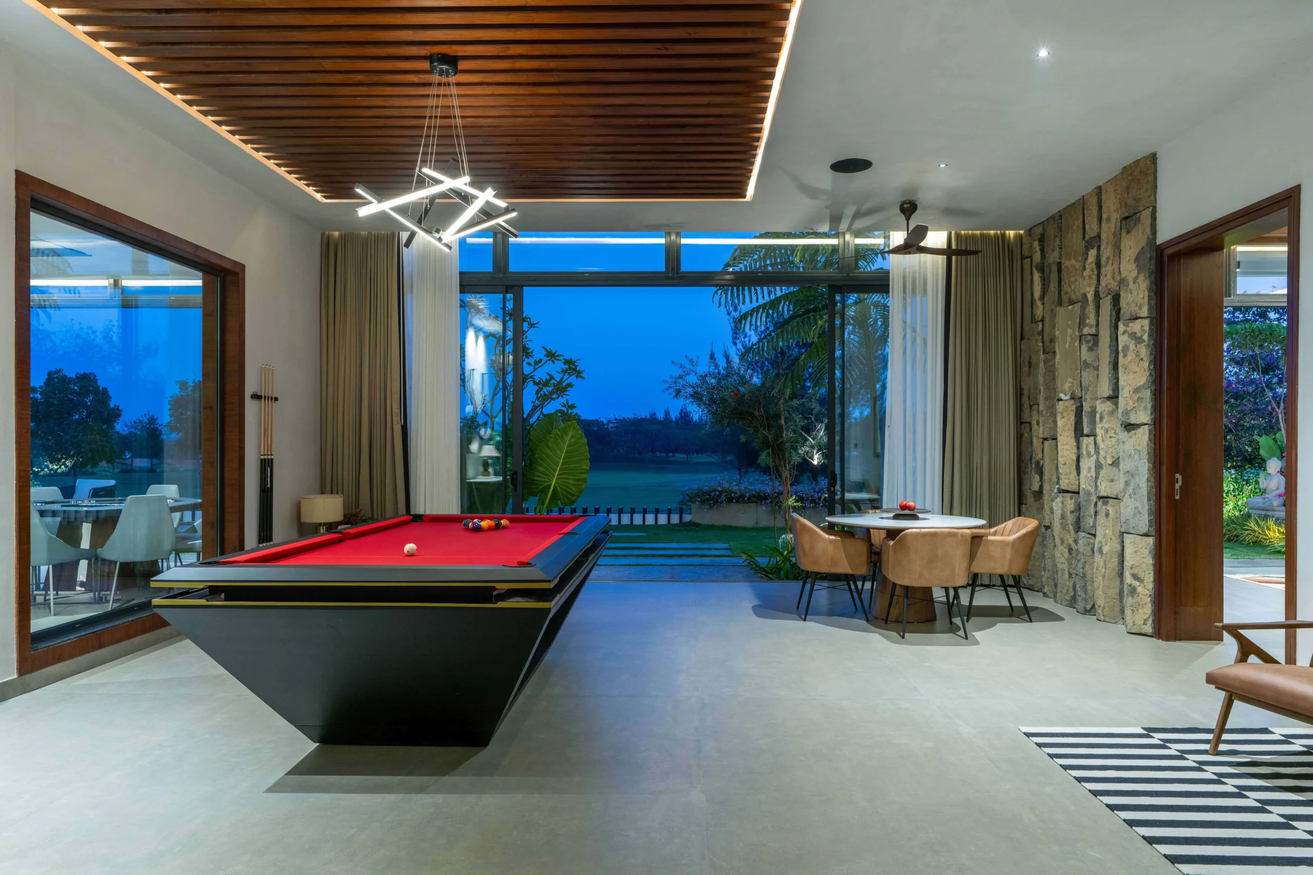 Minimal interiors with large sliding glass doors that seamlessly connect the indoors with the golf course views