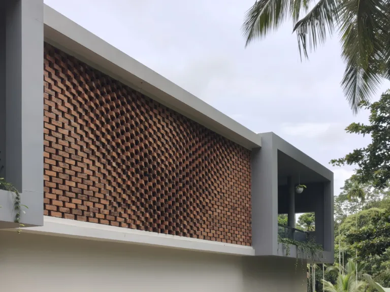 Locally available brick is articulated as a porous, three-dimensional screen that filters harsh sunlight, encourages air movement and creates privacy while giving the façade its distinctive depth and texture (Image Credit – Raving Dots Studio)