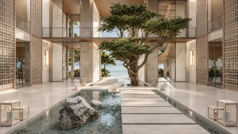 O Resort, a resort project in North India - The internal courtyard uses a reflecting water channel and a mature tree as landscape anchors, framed by timber- screened façades that filter daylight into the surrounding circulation spaces (Image Credit - Habitat Architects)