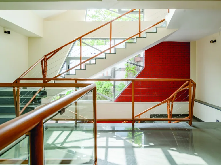 The glass panels, arranged in an irregular pattern, create a dynamic interaction with light